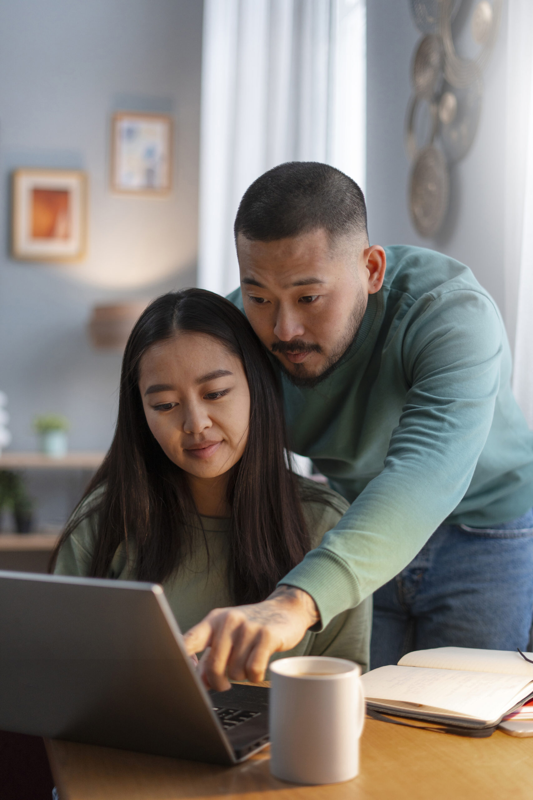 parent helping student do schoolwork on laptop